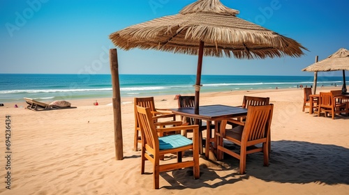 chairs for relaxing and sunbathing with umbrellas beside sea beach