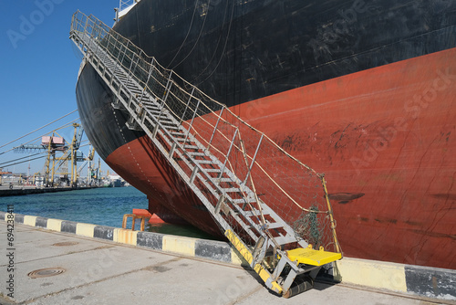 cargo ship gangway lowered to the pier at the port