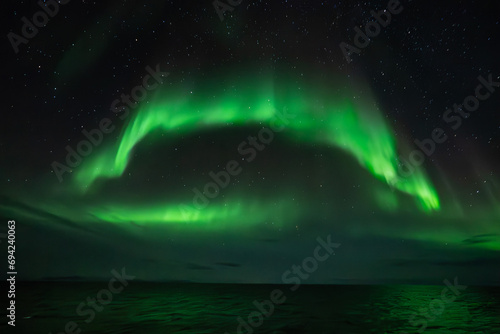 Green northern light, aurora borealis above sea