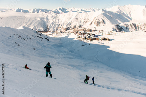 Four skiers stand at the foot of the mountain after skiing down