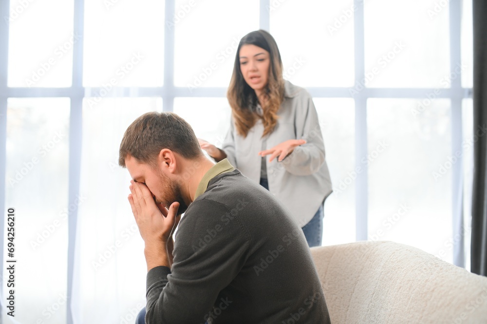 Family conflict, quarrel, misunderstanding. The woman shouts at her husband, in despair, crying Family conflict, quarrel, misunderstanding. The woman shouts at her husband, in despair, crying