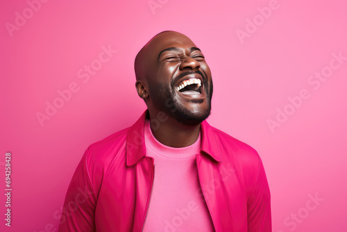 portrait of a black man dressed in pink laughing