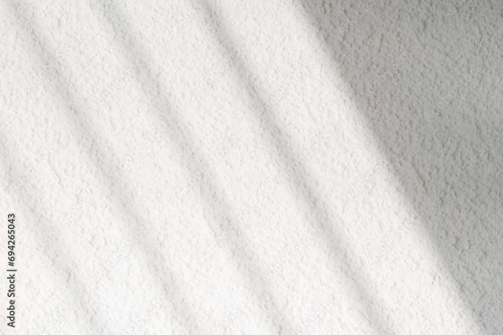 Naklejka premium Textured white wall with organic drop diagonal shadow of window