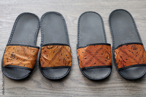 a pair of batik patterned sandals, one of the works of Indonesian MSMEs or small industries. typical Indonesian sandals for hotel guests. photo