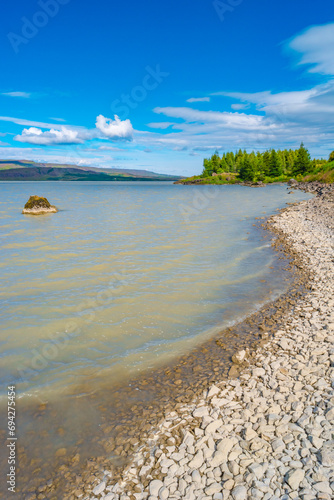 Cover page with huge Lagarfljot lake in Iceland at sunny day and blue sky, summer photo