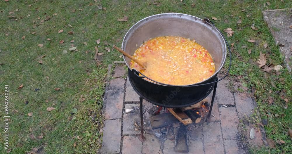 Preparation of bean soup in a cauldron on the open fire in nature Preparation of bean soup in a cauldron on the open fire in nature