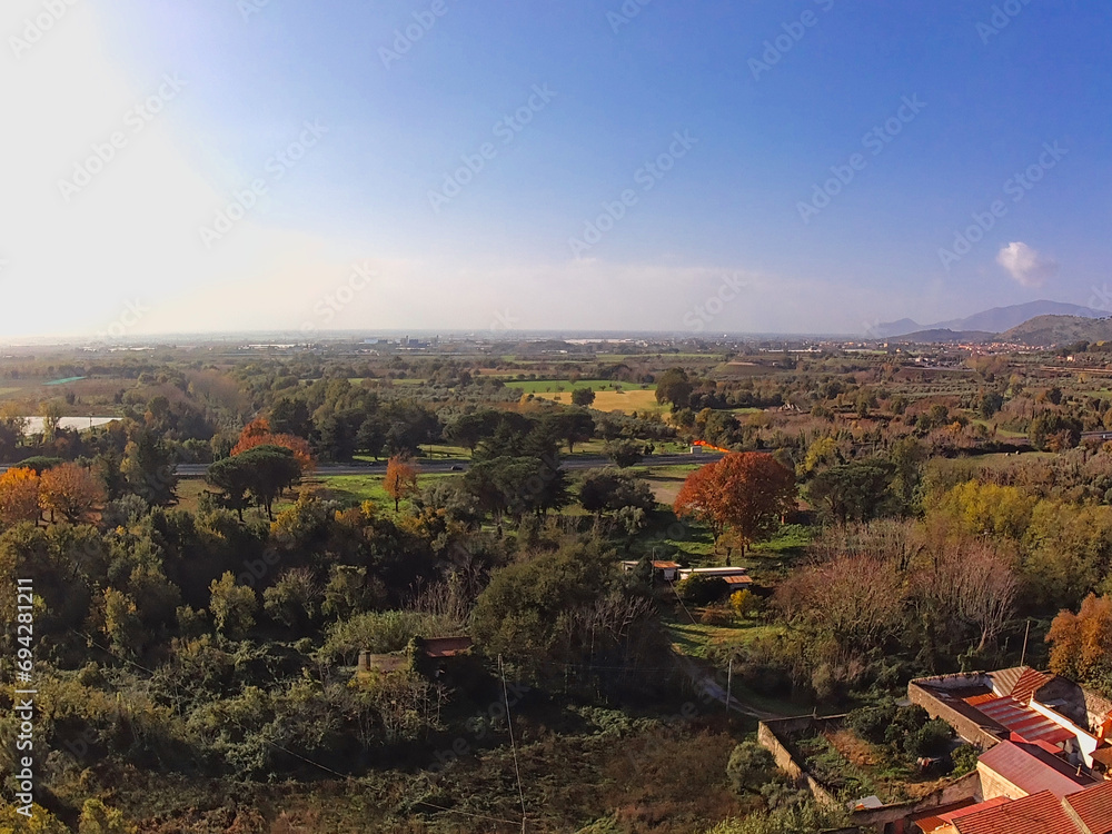 aerial view of autumn colored plain countryside crossed by an old street
