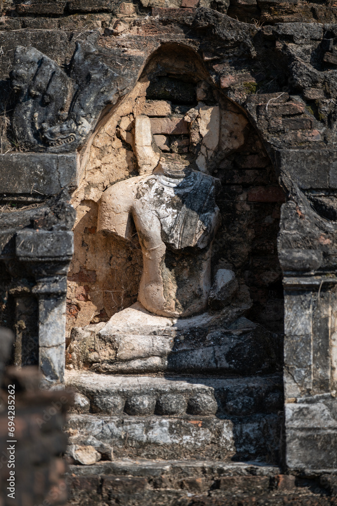 damaged buddha statue in Wat Chetuphon at Sukhothai Historical Park.