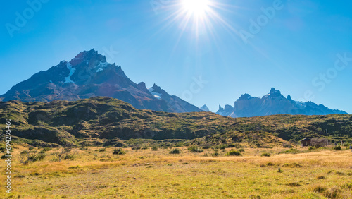 Torres del Paine National Park, Patagonia, Chile, Magical colorful sunset at major peaks, standing high towers surrounded by austral forests and pampas at direct light photo