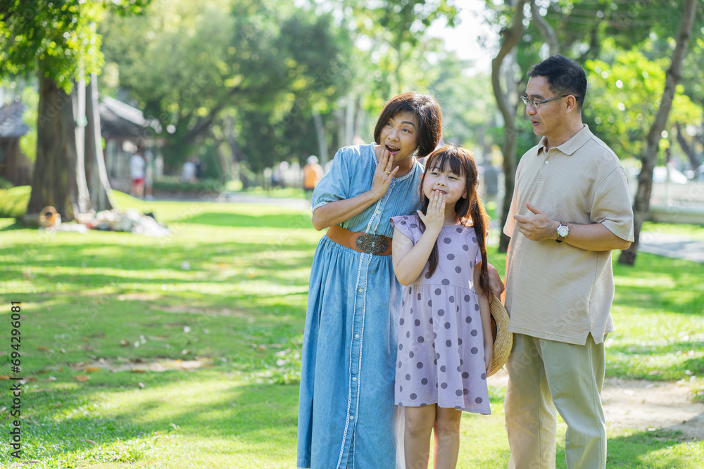Happy family spending the weekend together in a public park outdoors. Concept of a healthy life and insurance plans. Happy family spending the weekend together in a public park outdoors. Concept of a healthy life and insurance plans.