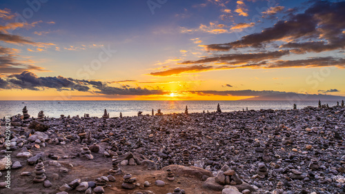 Playa del Veril, Costa Adeje, Tenerife, Spain. Rocks at the beach at sundown. photo