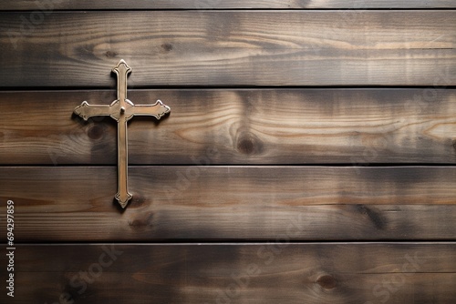 Wooden christian cross on a wooden background.Christian religion concept.