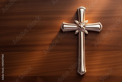 Wooden christian cross on a wooden background.Christian religion concept.
