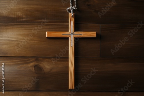 Wooden christian cross on a wooden background.Christian religion concept.
