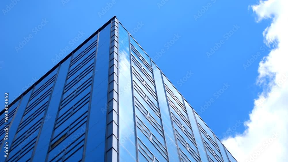 Tall big office building with white clouds, blue clean sky background. Time lapse, tower, highrise, facade, high, estate, center, glass, glazed, windows, place, city, wall, cloud, hd. ProRes 422 HQ. Tall big office building with white clouds, blue clean sky background. Time lapse, tower, highrise, facade, high, estate, center, glass, glazed, windows, place, city, wall, cloud, hd. ProRes 422 HQ.