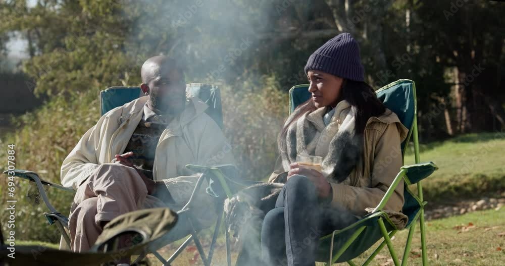 Nature, camping or couple by campfire to relax on holiday, vacation or weekend break on outdoors. Travel, black men or woman on chair talking, speaking or enjoying conversation together as campers Nature, camping or couple by campfire to relax on holiday, vacation or weekend break on outdoors. Travel, black men or woman on chair talking, speaking or enjoying conversation together as campers