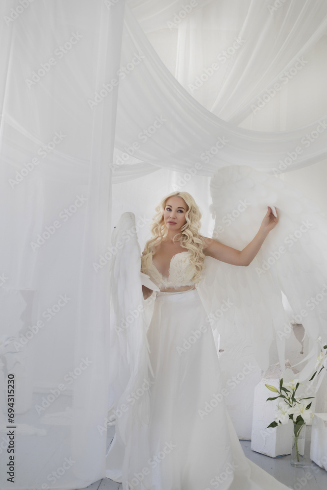angel girl in a photo studio. White background .
