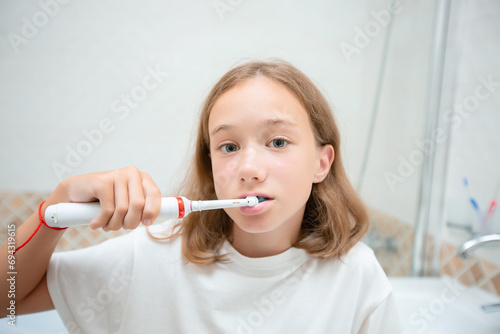 Dental hygiene. Happy little blonde girl brushing her teeth. Healthy concept