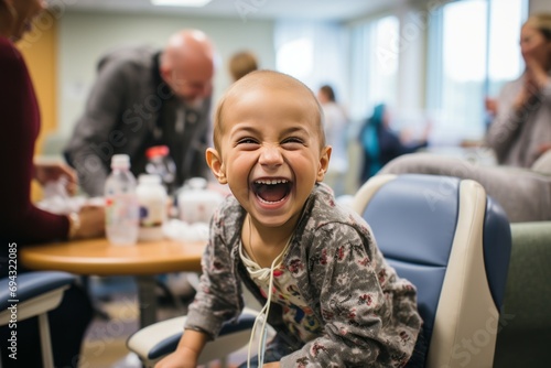 An adorable baby undergoes cancer treatment in a hospital. The brave toddler smiles and plays with toys, he does not give up and is confident of victory over the terrible disease. photo