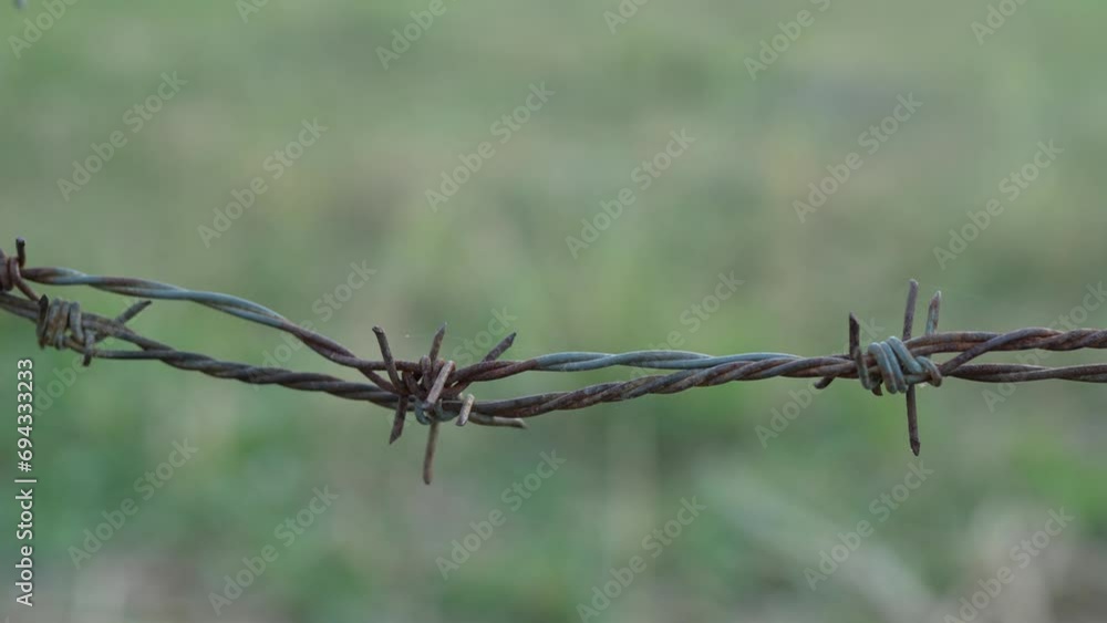 Rusted barbed wire surrounds the restricted area. Rusted barbed wire surrounds the restricted area.