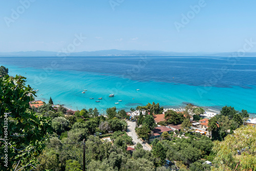 Afytos, Greece, July 17, 2023. Situated on top of a hill, the village of Afitos overlooks the Toronean Gulf, with a popular beach below. © JeanMarc