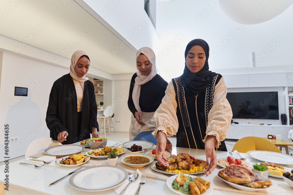 Group of young Arab women come together to lovingly prepare an iftar table during the sacred Muslim month of Ramadan, embodying the essence of communal unity, cultural tradition, and joyous Group of young Arab women come together to lovingly prepare an iftar table during the sacred Muslim month of Ramadan, embodying the essence of communal unity, cultural tradition, and joyous