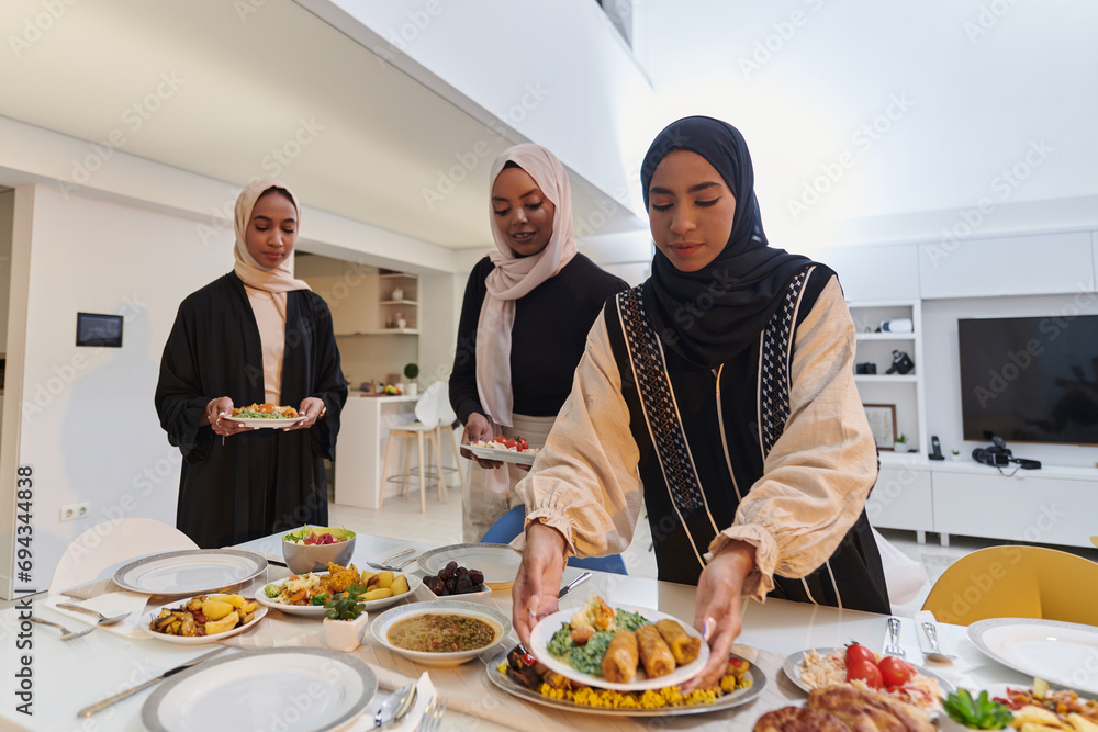 Group of young Arab women come together to lovingly prepare an iftar table during the sacred Muslim month of Ramadan, embodying the essence of communal unity, cultural tradition, and joyous Group of young Arab women come together to lovingly prepare an iftar table during the sacred Muslim month of Ramadan, embodying the essence of communal unity, cultural tradition, and joyous