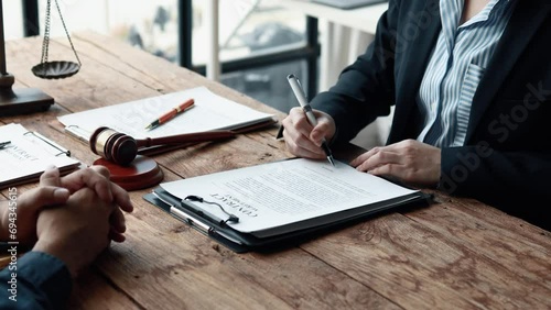 Attorney gives the client a pen to sign a contract admitting fraud, lawyer admits a fraud case in which client is a victim and will sue defendant who is a commercial partner. Fraud litigation concept. photo