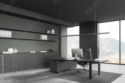 Grey office interior with ceo workspace near window, pc monitor and sideboard