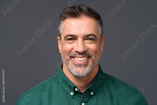 Happy middle aged business man entrepreneur, smiling mature professional executive manager, confident businessman leader investor wearing green shirt isolated on gray, headshot close up portrait.