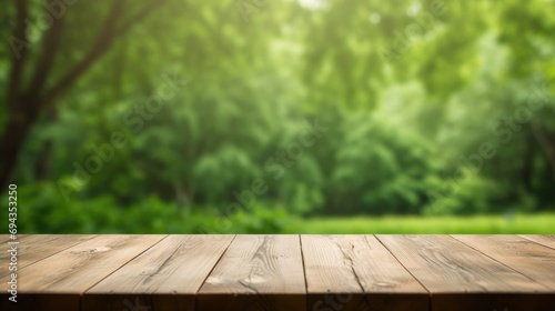 Empty wooden table with green background 