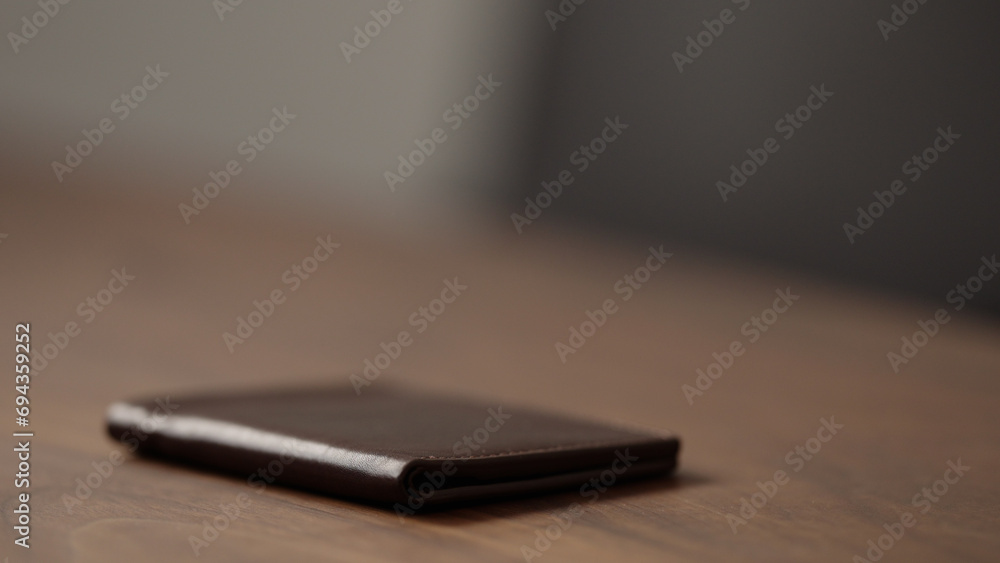 closeup leather wallet on wood table closeup leather wallet on wood table