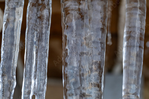 Close up of a large icicles with more melting icicles beside