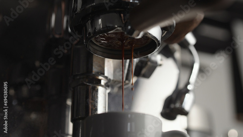 Low angle of pulling espresso shot with naked portafilter