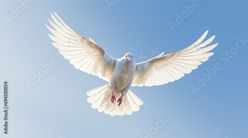 A dove in mid-flight  wings spread  against a clear blue sky.