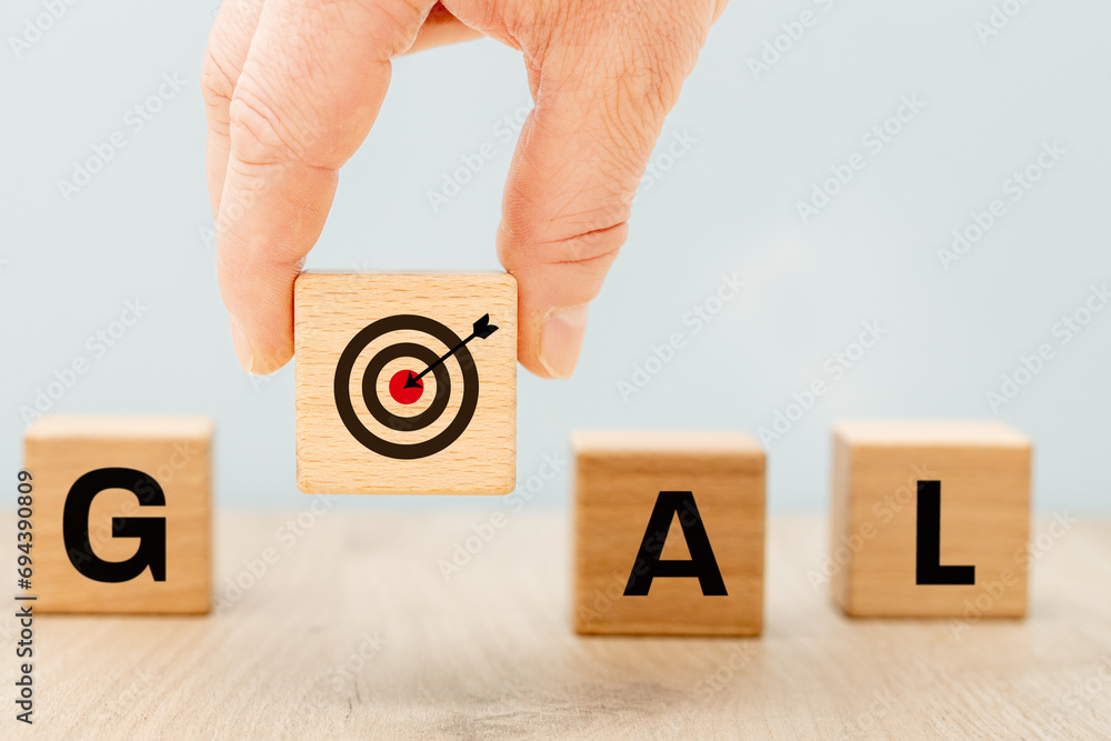 Goal symbol A raised dice with a target and an arrow in the middle, forming the word