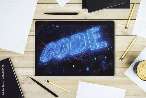 Creative Code word sign on modern digital tablet display, international software development concept. Top view. 3D Rendering photo