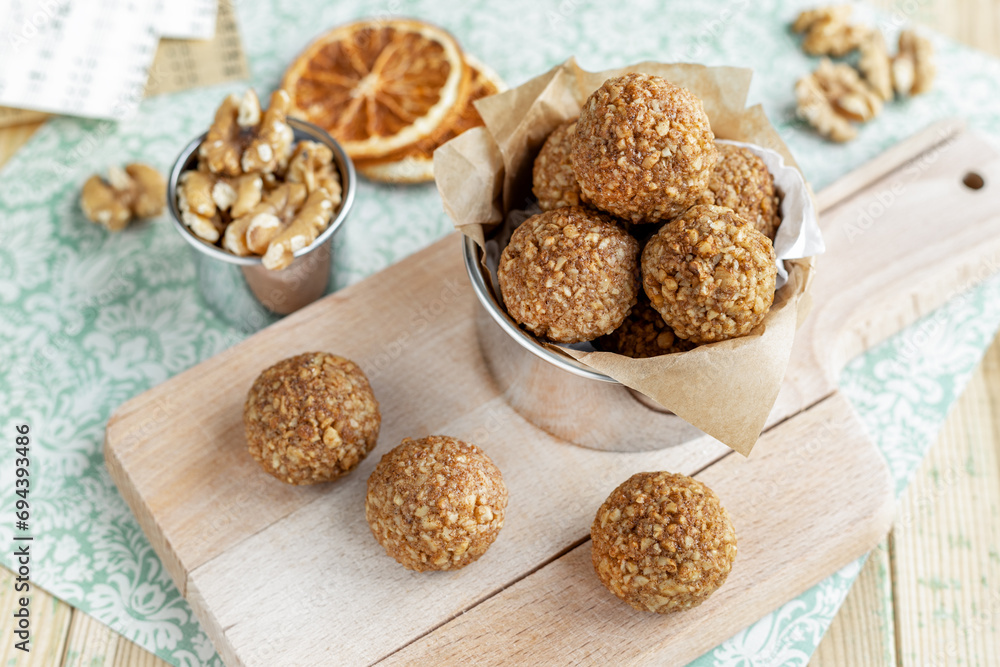 Caramelized walnut Bliss Balls, nut and orange sweets on board Caramelized walnut Bliss Balls, nut and orange sweets on board