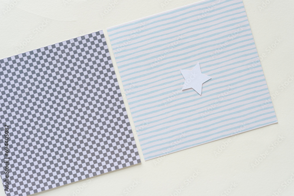 Fototapeta premium square paper tiles with plaid grid and stripes with small white star on blank paper