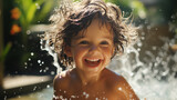 Wonderful child bathing in an outdoor pool with splashes and pleasure in a summer garden on a bright afternoon