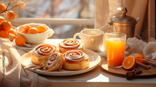 Breakfast with orange juice and croissant. Still life with pastries and coffee. Cinnabons. Baked goods and coffee. Morning coffee cup. Breakfast. Glass of juice. Good morning. Delicious breakfast food