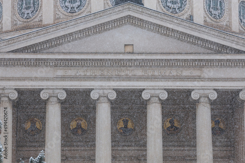 Winter snowfall photo in Bucharest. Beautiful detail view during a snowfall over Romanian Atheneum landmark building from Romania. Travel to Bucharest. photo