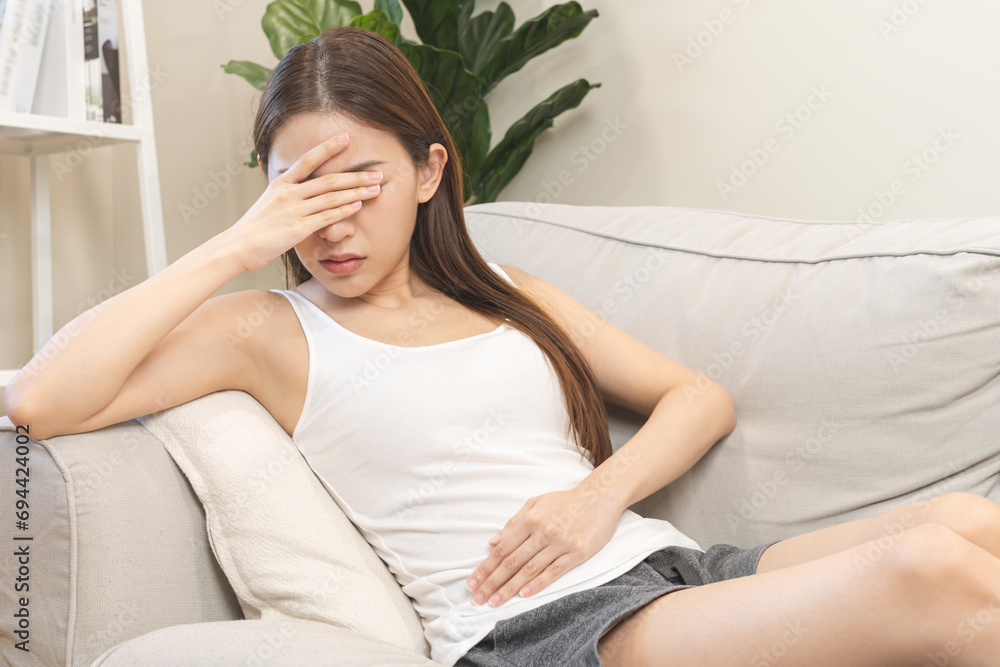 Flatulence asian young woman, girl hand in stomach ache, suffer from food poisoning, abdominal pain and colon problem, gastritis or diarrhoea. Patient belly, abdomen or inflammation, concept. Flatulence asian young woman, girl hand in stomach ache, suffer from food poisoning, abdominal pain and colon problem, gastritis or diarrhoea. Patient belly, abdomen or inflammation, concept.
