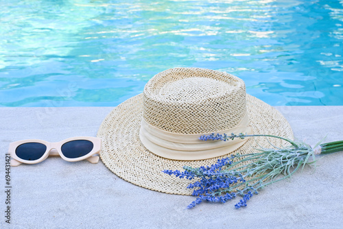 Straw hat, sunglasses, beside the pool party.