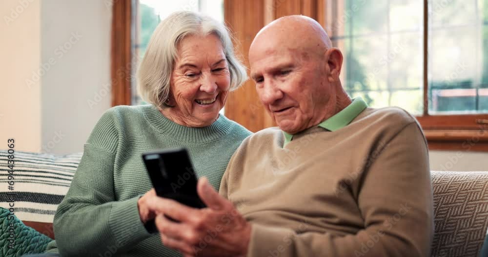 Reading, phone and senior couple relax in home with app or streaming a video on social media with internet. Scroll, cellphone and people in retirement with funny meme online or news in living room Reading, phone and senior couple relax in home with app or streaming a video on social media with internet. Scroll, cellphone and people in retirement with funny meme online or news in living room
