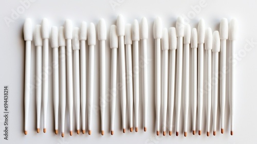 a neatly arranged cotton buds  emphasizing their cleanliness and precision  perfectly isolated on a spotless white surface.