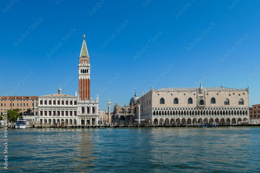 Scenic view of the channel Canala Grande tower of St Mark's Campanile in city of Venice, Veneto, Northern Italy, Europe. Venetian architectural landmarks. Romantic vacation. Speed boat passing by