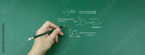 E-learning concept: teacher writes pencil in front of classroom Write a mathematical formula to calculate engineering technology education highly creative concept Knowledge focused on school issues