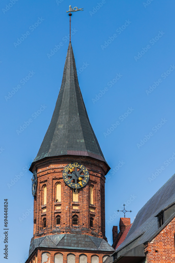Spire and tower clock of the Konigsberg Cathedral on a summer day