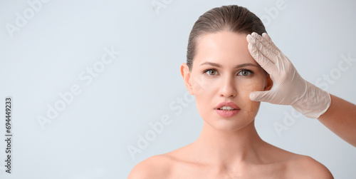 Plastic surgeon touching fa...